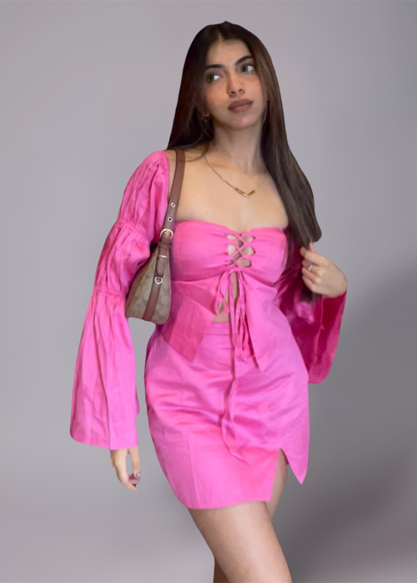 Woman wearing a puff sleeve pink top and mini slit skirt