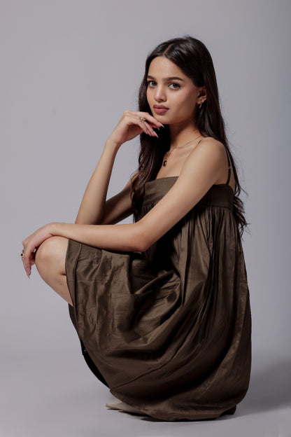 A mocha brown, bubble-like silhouette dress with adjustable straps, knee-length,