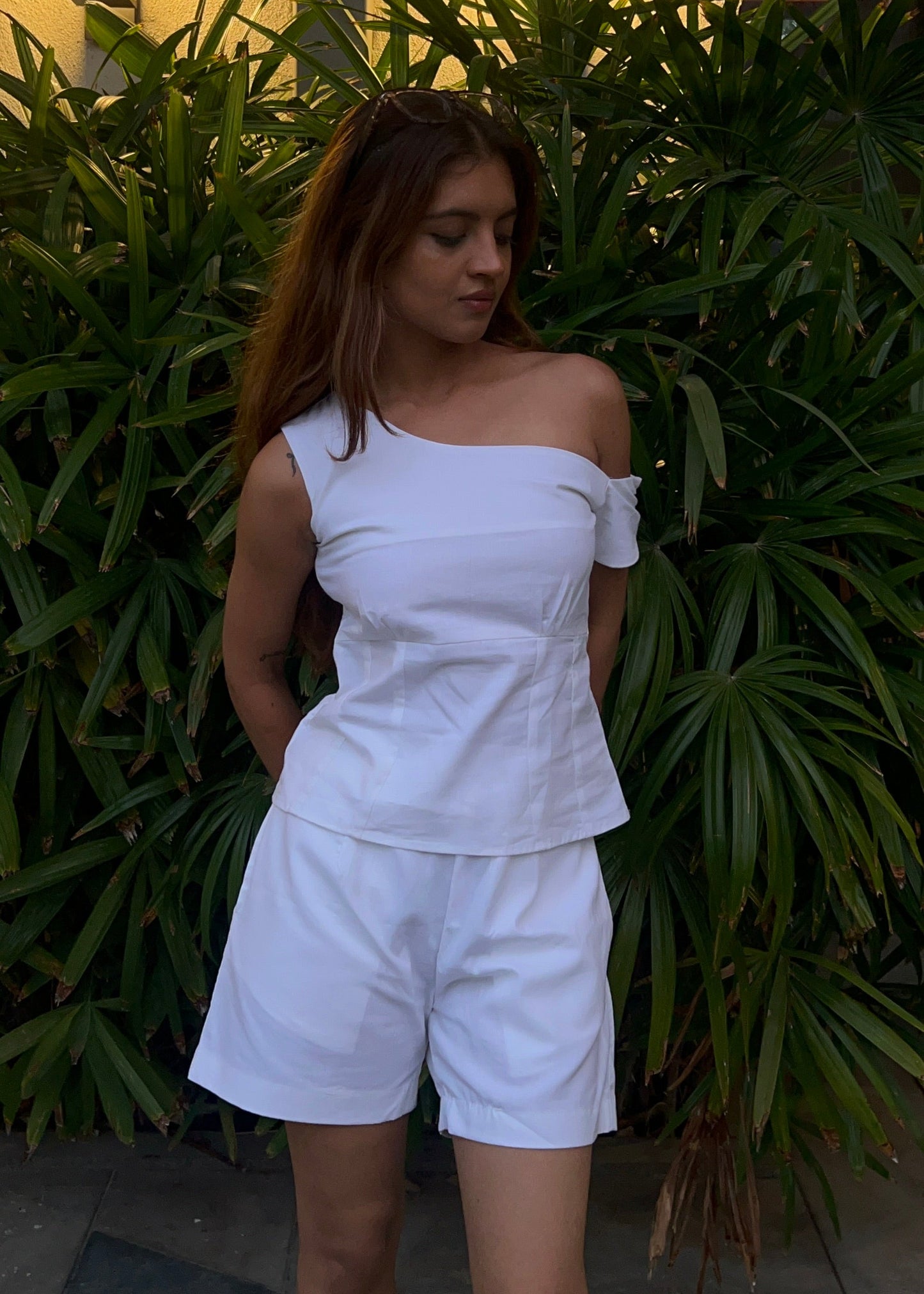 white co-ord set for women, crafted in 100% breathable bamboo cotton, structured asymmetrical one-shoulder top with side zip with relaxed-fit shorts WITH POCKETS and comfortable waistband