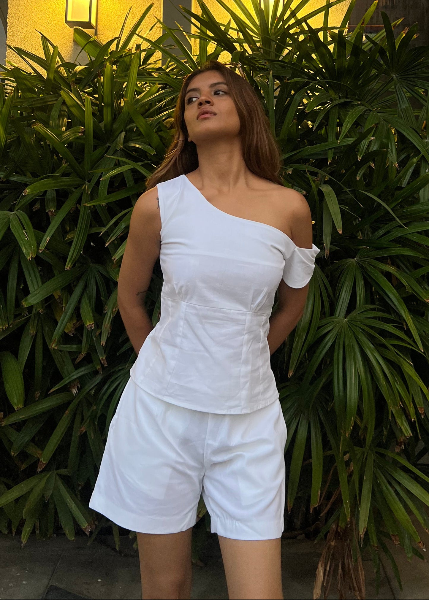 white co-ord set for women, crafted in 100% breathable bamboo cotton, structured asymmetrical one-shoulder top with side zip with relaxed-fit shorts WITH POCKETS and comfortable waistband