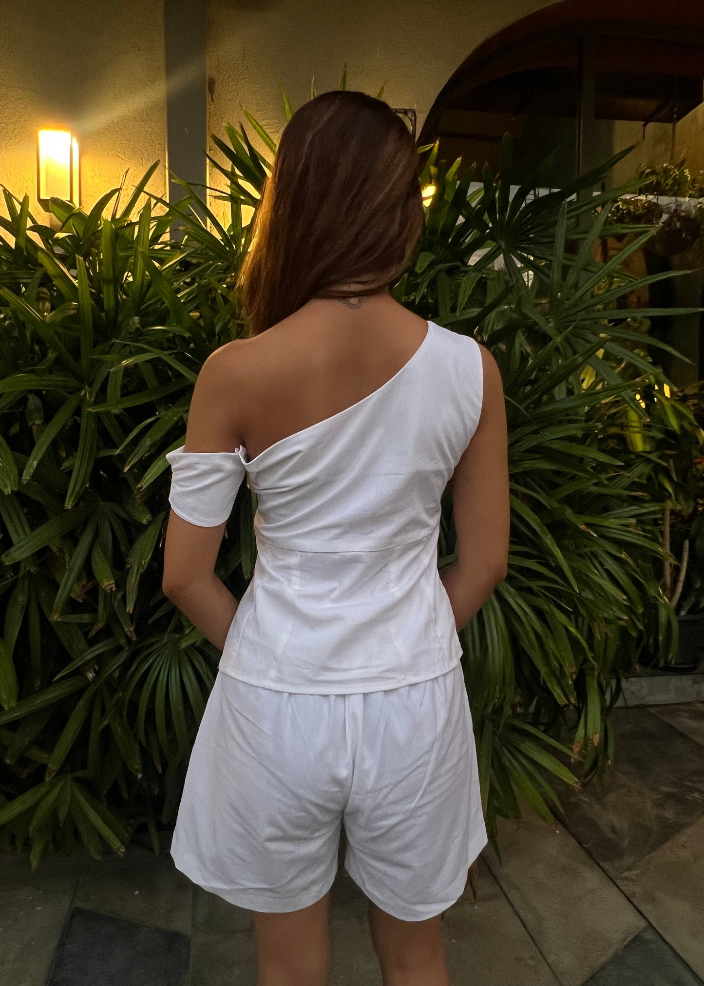 white co-ord set for women, crafted in 100% breathable bamboo cotton, structured asymmetrical one-shoulder top with side zip with relaxed-fit shorts WITH POCKETS and comfortable waistband