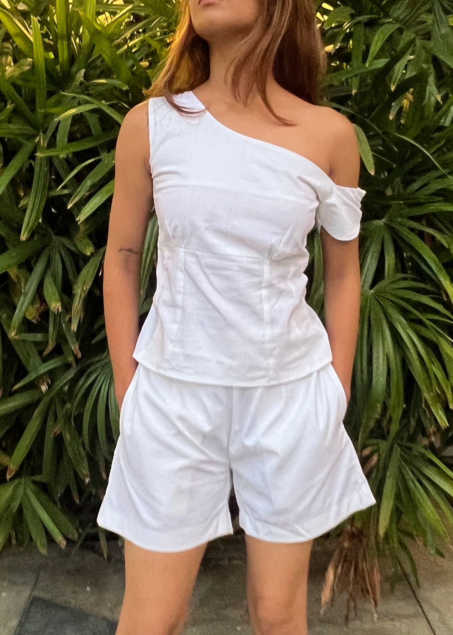 white co-ord set for women, crafted in 100% breathable bamboo cotton, structured asymmetrical one-shoulder top with side zip with relaxed-fit shorts WITH POCKETS and comfortable waistband