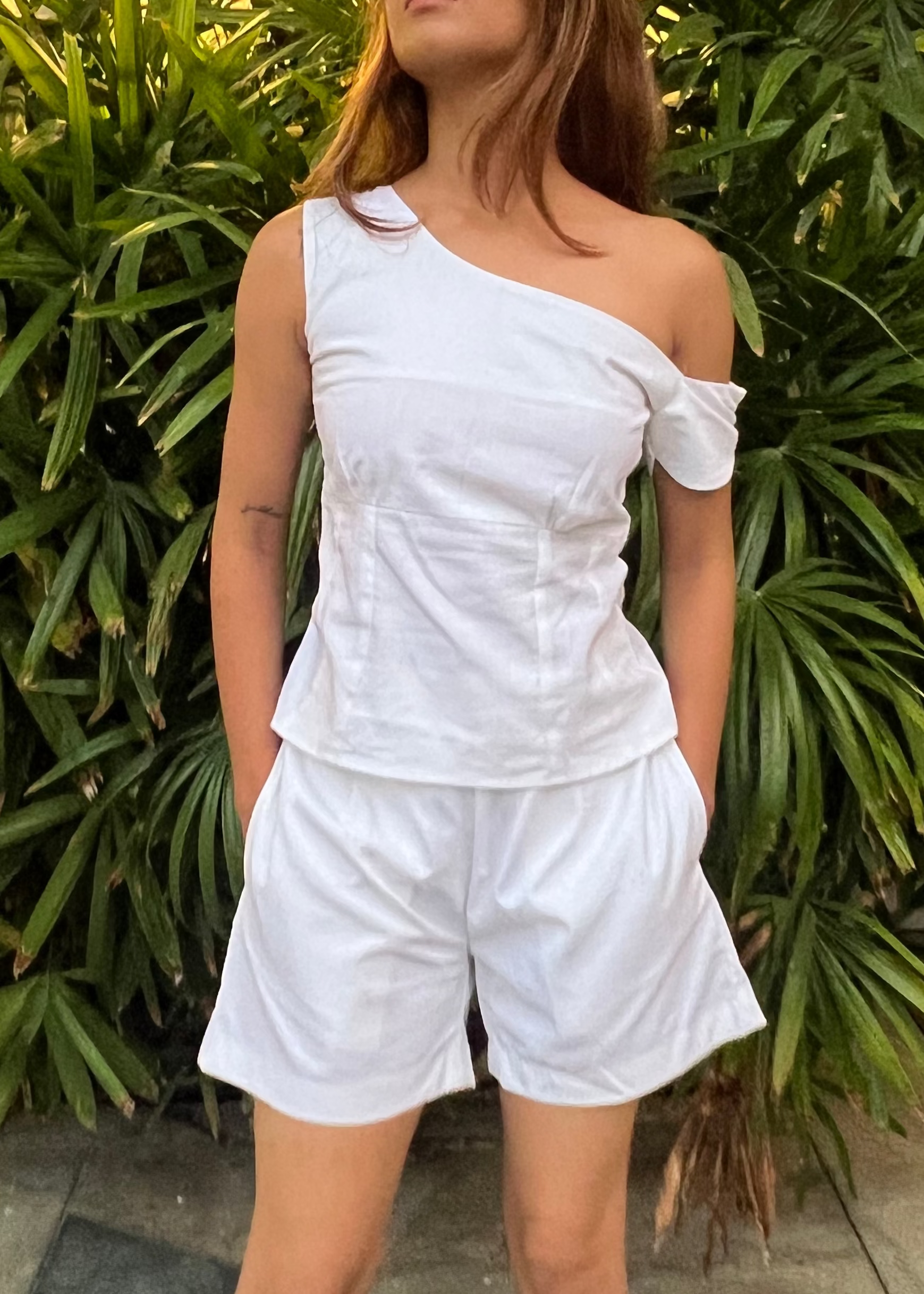 white co-ord set for women, crafted in 100% breathable bamboo cotton, structured asymmetrical one-shoulder top with side zip with relaxed-fit shorts WITH POCKETS and comfortable waistband