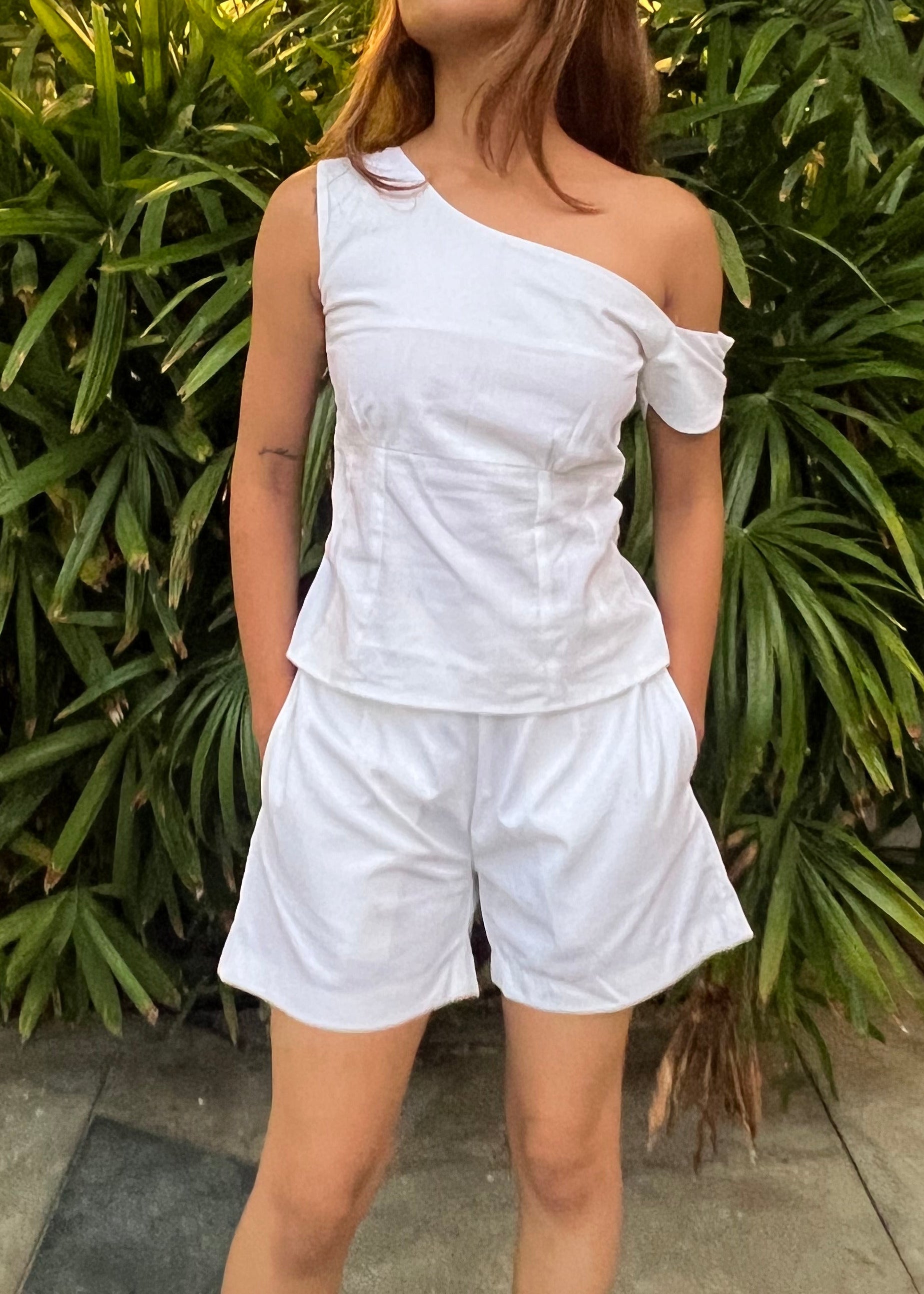 white co-ord set for women, crafted in 100% breathable bamboo cotton, structured asymmetrical one-shoulder top with side zip with relaxed-fit shorts WITH POCKETS and comfortable waistband