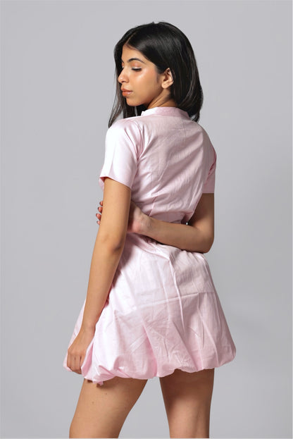 Model wearing a pink bubble hem cotton dress with short sleeves and A-line silhouette from Hyghbreed