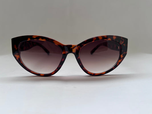 Tortoiseshell cat-eye sunglasses on a light gray background