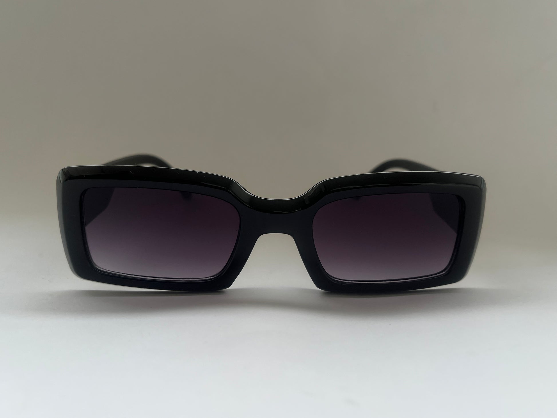 Black glossy sunglasses with dark lenses 