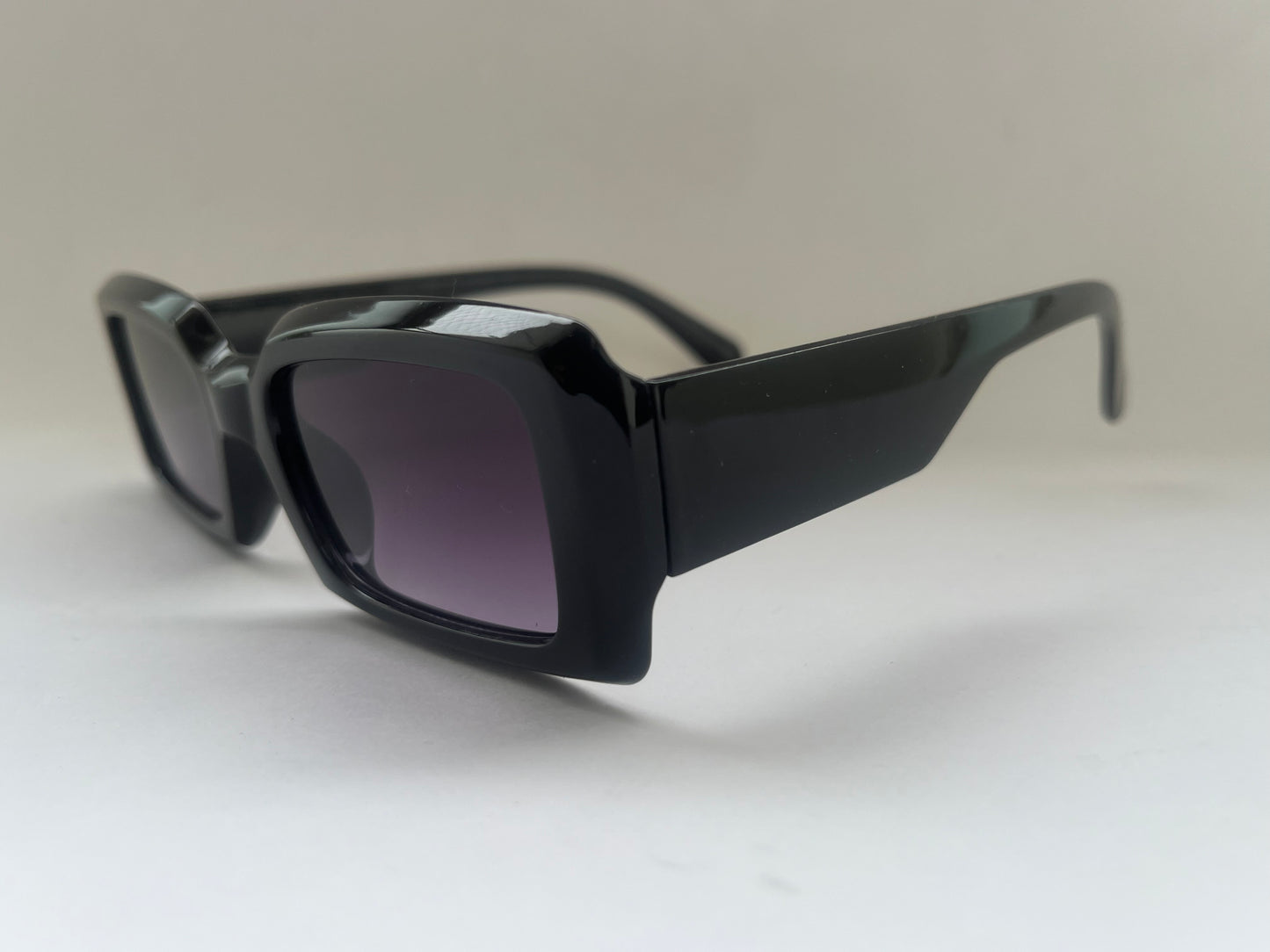 Black glossy sunglasses with dark lenses 
