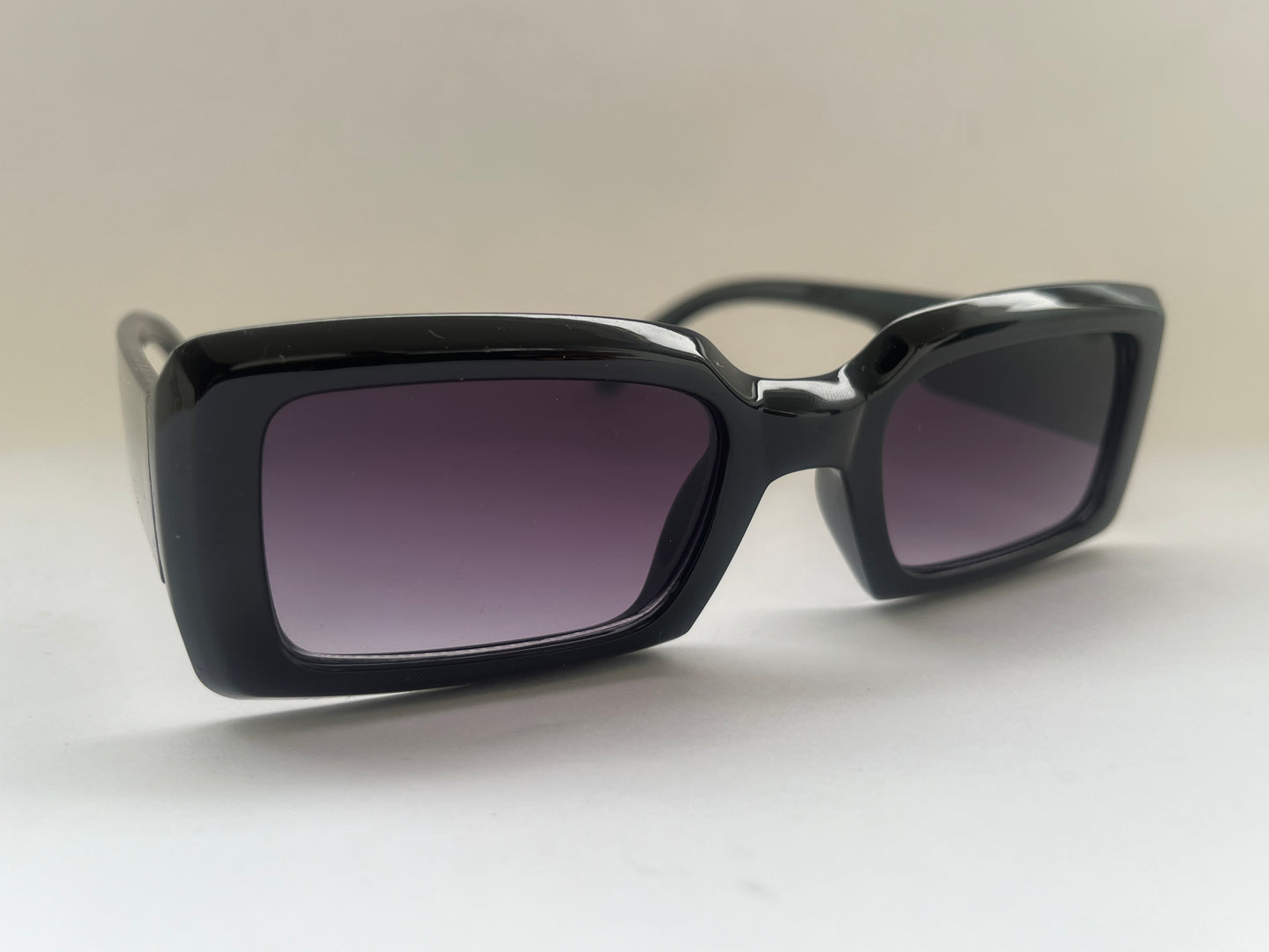 Black glossy sunglasses with dark lenses 