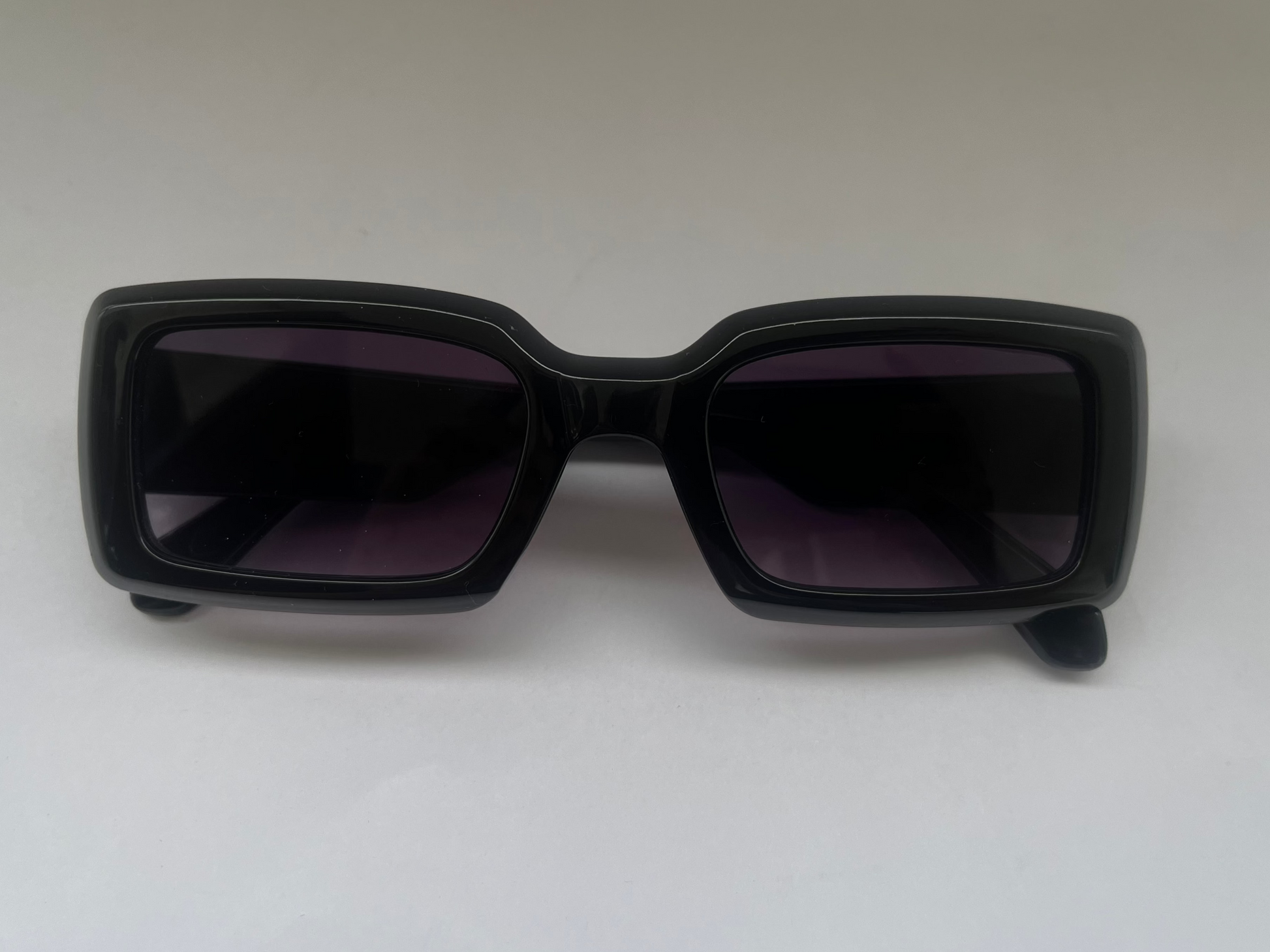 Black glossy sunglasses with dark lenses 